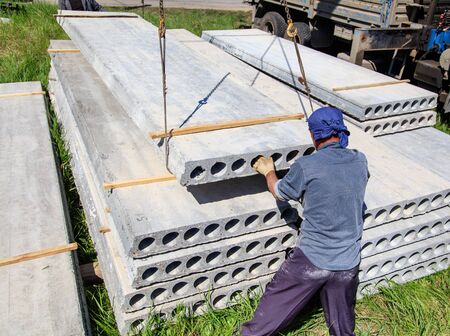 Installing concrete slabs at a construction site at home .