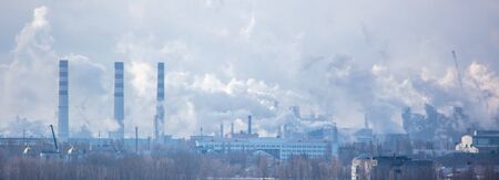 The smoke from the pipes of the metallurgical plant pollutes the environmentの写真素材