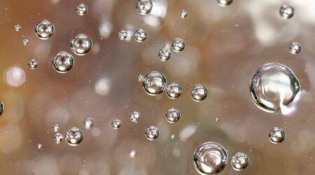 Bubbles of air on the surface of water as an abstract background .の写真素材