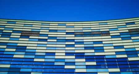 Blue windows of a modern building against the sky .の写真素材