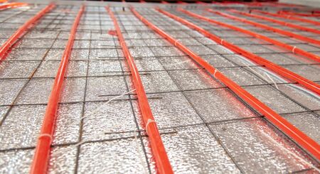 Installing a hose for underfloor heating in the room.の写真素材