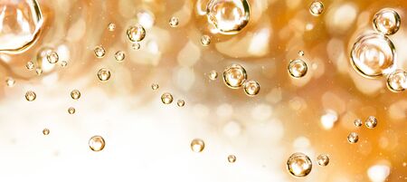 Bubbles of air on the smooth surface of golden water as an abstract background .の写真素材