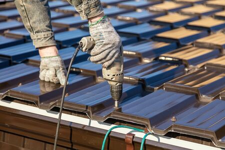 Installation of metal drain on the roof of the house .の写真素材