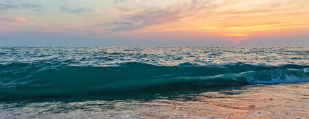 Waves on the seashore at sunset.