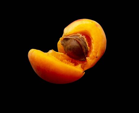 Ripe apricot isolated on a black background.の写真素材