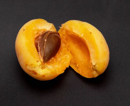Ripe apricot on a black background.の写真素材