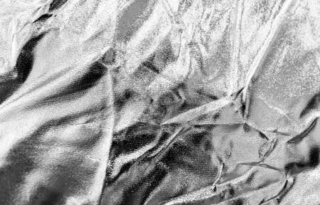 Crumpled silver material as abstract background .