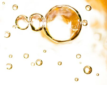 Bubbles of air on the smooth surface of golden water as an abstract background .の写真素材