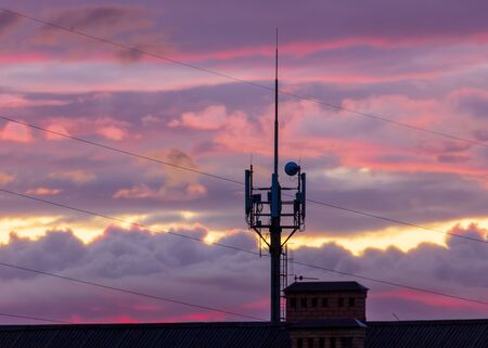 Antenna for cell phones at sunset.の写真素材