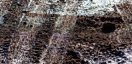 Traces of a car on dirty soil.