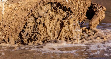 SUV wheel stalled in mud and water.の写真素材