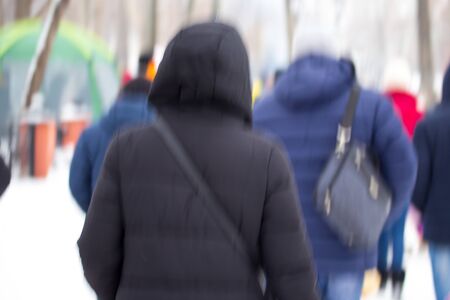 People walk in the city in winter. Bokehの写真素材