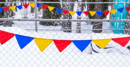 Festive flags in the park in winter.の写真素材