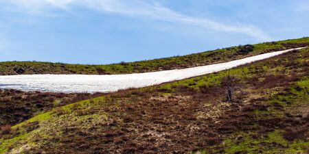 Snow on the slopes of the mountains .の写真素材