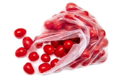 Red cherry tomatoes in a package on a white background.の写真素材