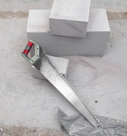 Foam saw and bricks in a house under construction.の写真素材