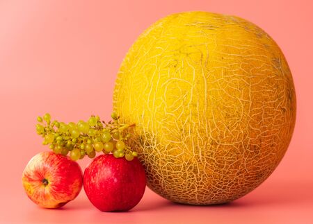 Melon and fruit on a pink background.の写真素材