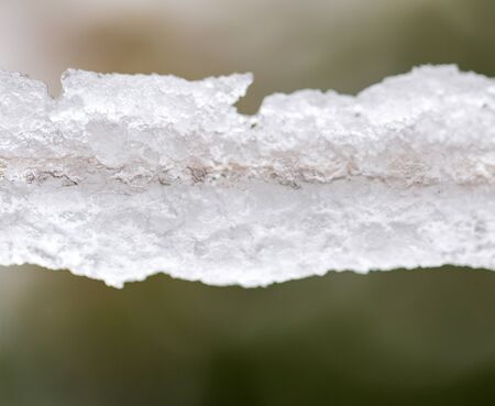 Snow on a clothesline as background.の写真素材