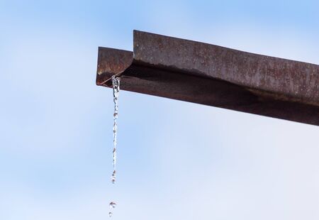 Water pours from the drain on the house.の写真素材