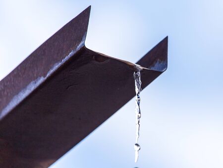 Water pours from the drain on the house.の写真素材