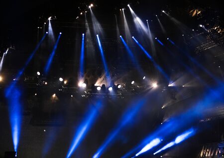 Blue light on a rock concert stage as background.