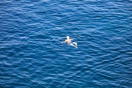 Bodrum, Turkey - August 21, 2019: A girl swims in the Aegean Sea in Turkey.のeditorial素材