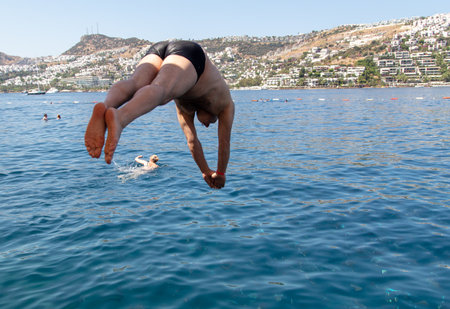 Bodrum, Turkey - August 21, 2019: A man swims in the water of the Aegean Sea in Turkey.のeditorial素材