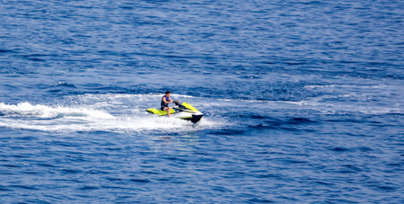 Bodrum, Turkey - August 21, 2019: Motorcycle in the water of the Aegean Sea in Turkey.