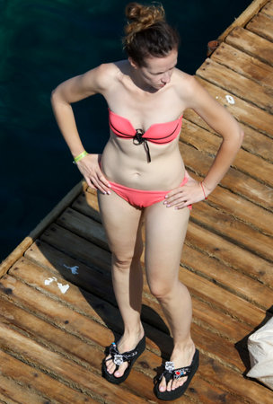 Bodrum, Turkey - August 21, 2019: Girl sunbathes on the beach of the Aegean Sea in Turkey.のeditorial素材