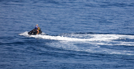 Bodrum, Turkey - August 21, 2019: Motorcycle in the water of the Aegean Sea in Turkey.