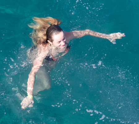 Bodrum, Turkey - August 21, 2019: A girl swims in the Aegean Sea in Turkey.のeditorial素材