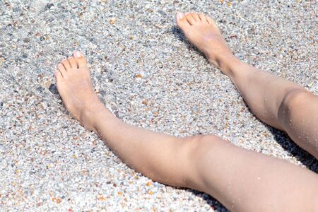Feet of a girl sunbathing in the sun.