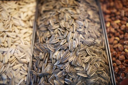 Salted and dried seeds on the counter in the market.の写真素材