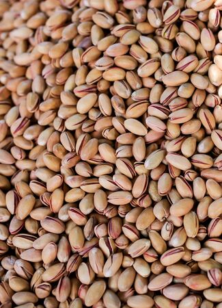 Pistachio nuts on the counter in the market.