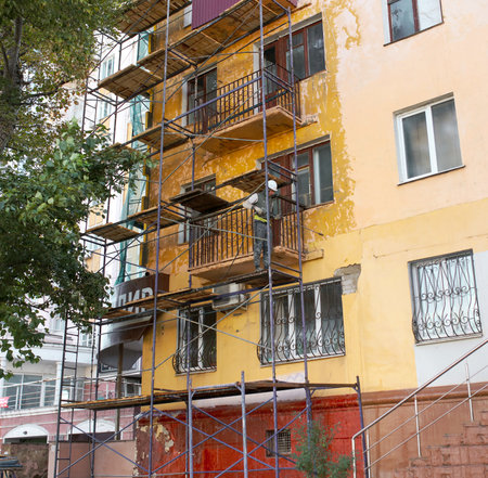 Lipetsk, Russia - September 21, 2019: Worker reconstructs the facade of a building on a city street.のeditorial素材