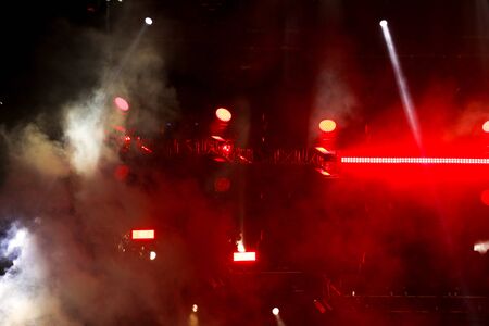 Red light on a rock concert stage as background.