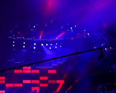 Blue light on a rock concert stage as background.