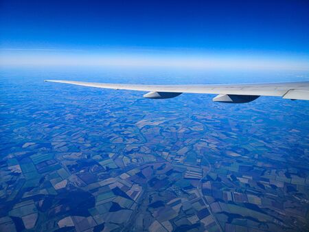 Airplane wing in flight. View from the porthole.