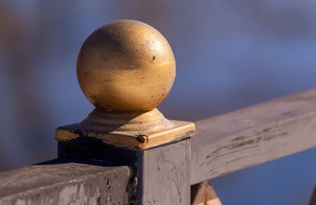 Golden ball on a metal fence.の写真素材