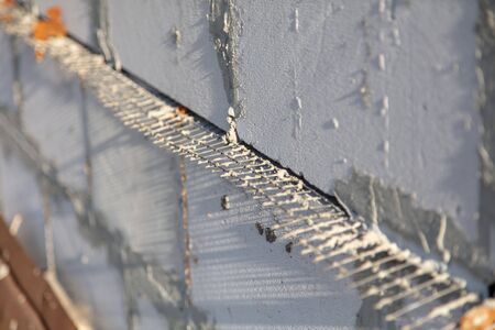 Metal mesh between the bricks in the concrete .の写真素材