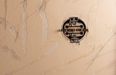 Wall in the house before repair as a backdrop.