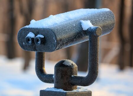 Binoculars in the park in winter at dawn.の写真素材