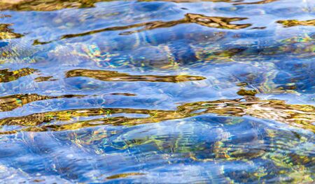 The surface of clear water in a pond as an abstract background.の写真素材