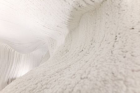 White walls of ice and snow in a cave.