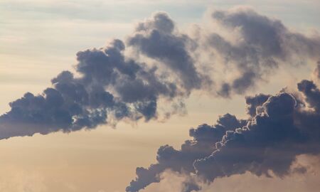 Smoke from the chimneys of a metallurgical plant at dawn.の写真素材