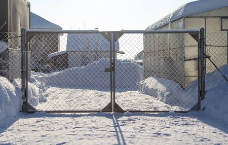 Gates in the garden in the snow in winter.の写真素材
