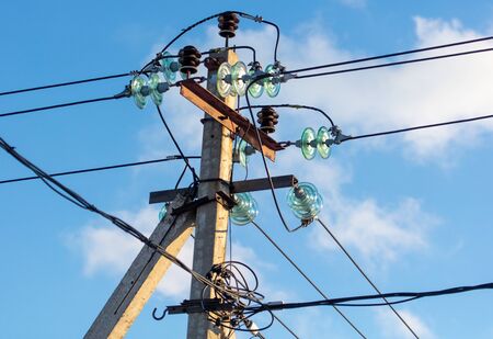Electric pole against the blue sky.