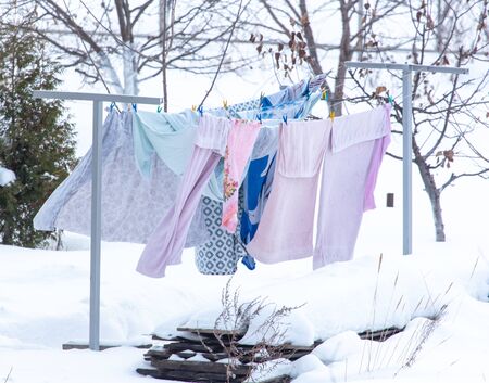 The clothes are dried on a rope in the winter.の写真素材