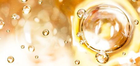 Bubbles of air on the smooth surface of golden water as an abstract background .の写真素材