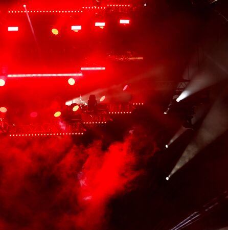 Red light on a rock concert stage as background.